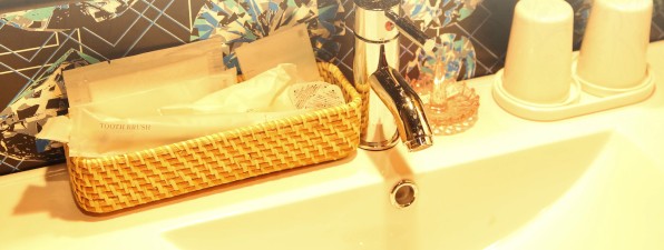 Free amenity set in a woven basket by the sink
