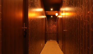 Quiet wood-panelled corridor leading to the rooms